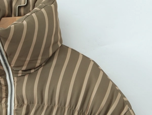 Detail of stand collar and zipper on brown striped padded puffer jacket for women