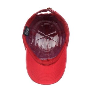 Internal view of a red cotton baseball cap with 100% cotton label and structured shape