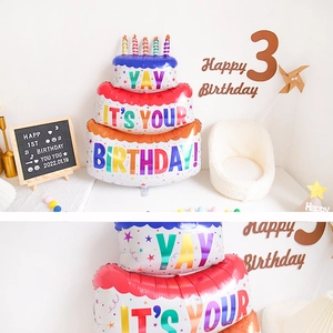 Detailed view of a colorful three-tier cake foil balloon with birthday party decorations