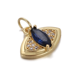 Close-up of 14K gold plated pendant with dark blue stone and zircon crystals