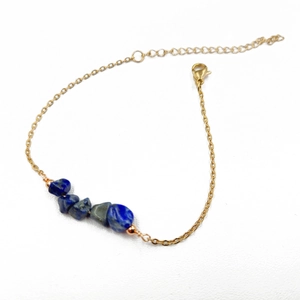 Minimalist gold chain bracelet featuring five irregular raw blue lapis lazuli stones