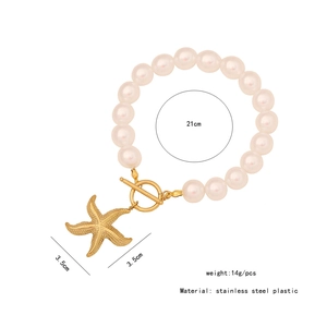 Macro view of gold starfish pendant and pearl beads with product dimension markers