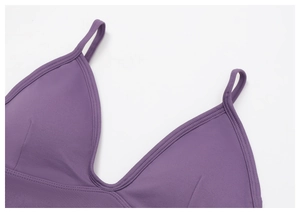 Macro view of purple yoga bra featuring fine ribbed texture and V-neckline detail