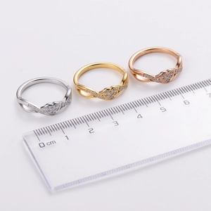 Three minimalist stainless steel infinity rings in silver, gold and rose gold colors