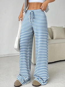 Detail of blue and white striped wide-leg trousers with high-waist drawstring texture