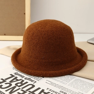 Detailed texture of a dark brown wool felt bucket hat with retro rolled brim design
