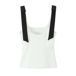 Detail of white camisole top with wide black contrast straps and minimalist bow design