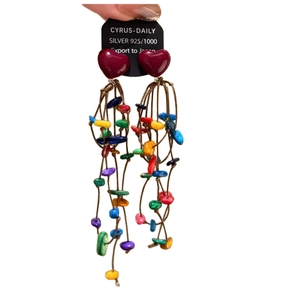 Colorful tassel heart earrings with silver needles and acrylic beads on white background
