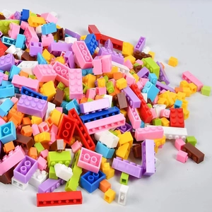 Detailed top view of assorted colorful building block bricks scattered on gray background
