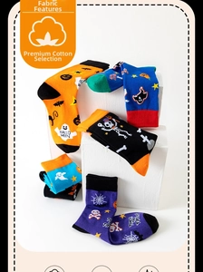 Detail view of cotton Halloween mid-calf socks with pumpkin and ghost patterns