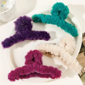 Macro detail of large plush hair claws in purple, blue, beige, and pink faux fur texture