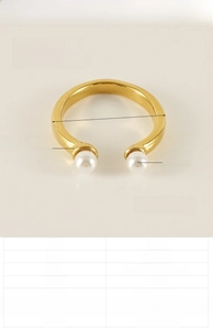 Detail view of gold stainless steel open ring with pearls showing size and weight specs