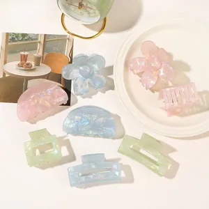Macro view of colorful iridescent PVC claw clips with pearlescent finish in a set of seven