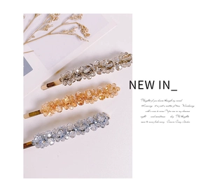 Detailed view of handmade crystal bead floral hair clips in grey, champagne, and blue colors