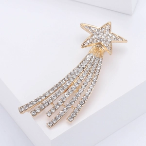 Elegant gold star tassel brooch with sparkling rhinestones on white geometry stand