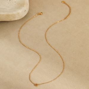 Close-up of golden stainless steel rose flower pendant necklace with adjustable chain