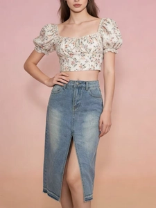 Women's floral crop top paired with a light blue high-waisted front slit denim skirt