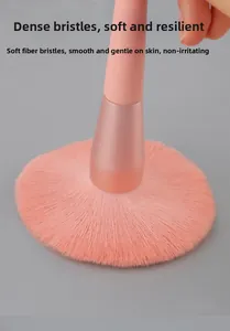Close-up of high-density soft pink fiber bristles on a powder brush showing flexibility