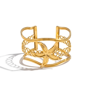 18K gold plated stainless steel wide cuff bracelet featuring hollow starfish design