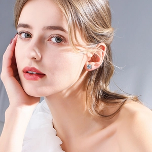 Elegant 925 sterling silver four-prong square-cut moissanite stud earrings on a model