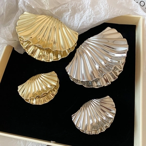 Elegant gold and silver shell hair claws in large and small sizes on velvet