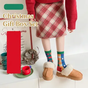 Set of 4 festive Christmas mid-calf socks with colorful plaid patterns in a gift box