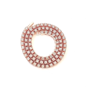 Detailed view of rose gold tennis necklace with sparkling cubic zirconia on white background