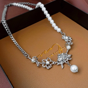 Elegant rose and pearl necklace with silver chain in luxury jewelry gift box display