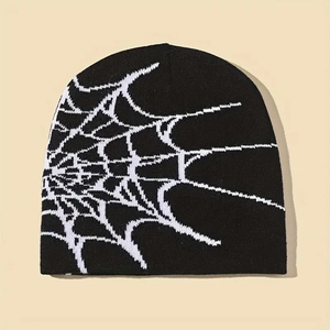 Detailed view of the fine knit texture and white spider web pattern on a black beanie