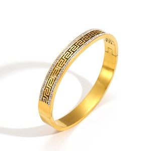 Luxury gold-plated stainless steel bangle featuring greek key pattern and dual rows of rhinestones