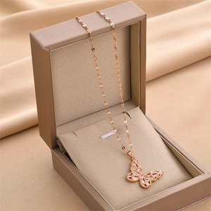 Rose gold butterfly pendant necklace with cubic zirconia in a beige jewelry gift box