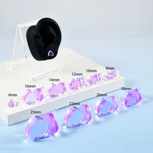 Purple heart-shaped glass ear plugs in 6-25mm sizes on a blue and white background