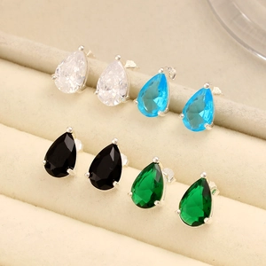 Macro shot of S925 silver teardrop earrings with zircon in blue, green, and black