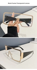 Detail of oversized black frame glasses with transparent lenses and diamond pattern temples