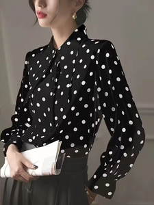 Elegant black polka dot blouse with lantern sleeves and a stylish tie neck collar