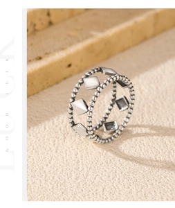 Macro detail of S925 sterling silver geometric ring with beaded chains and square plates