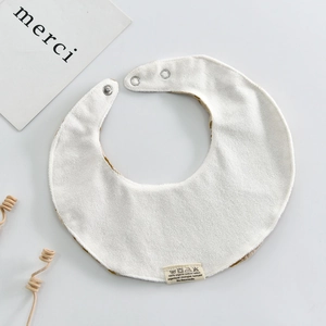 White organic cotton baby bib with snap fasteners and soft absorbent towel fabric
