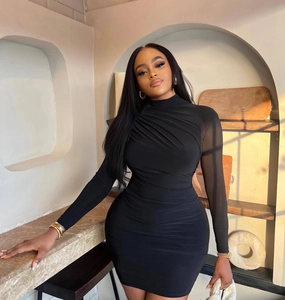 Close-up of black bodycon dress featuring elegant ruched details and a high neckline