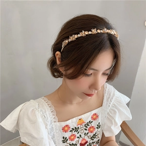 Close-up of luxury crystal headband with champagne beads on a female model