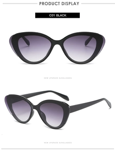 Detail view of black cat eye sunglasses with purple gradient lenses and wide wings
