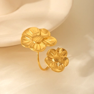 Detailed macro view of gold-plated titanium steel ring with intricate double floral petals