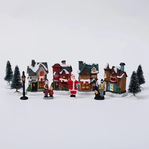 Detailed 10-piece Christmas village set with glowing houses, Santa and mini snow pine trees