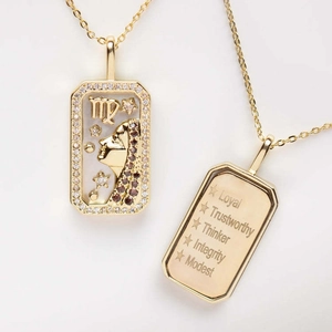 Detail of Virgo zodiac necklace showing shell inlay and engraved quality words