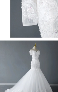 Macro view of floral lace embroidery and sequins on mermaid off-shoulder bridal gown