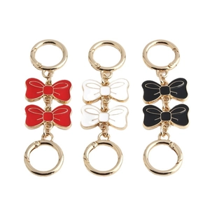 Golden bow bag strap extensions in red, white and black enamel with round spring clasps