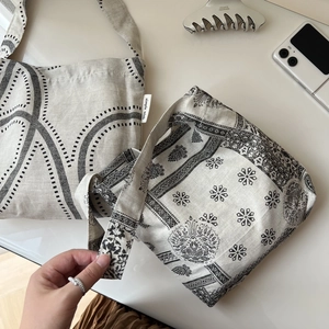 Detail of vintage paisley and geometric print cotton linen shoulder bags with simple wish label