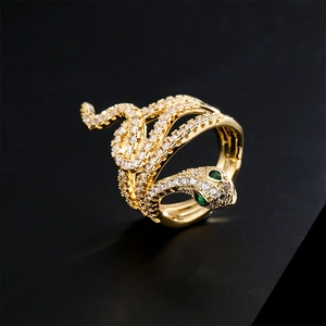 Luxurious snake-shaped ring in gold finish with white zircon and green gemstone eyes