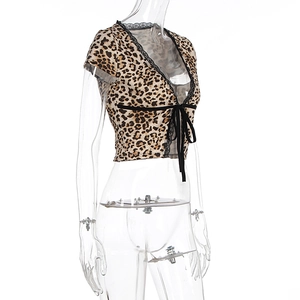 Detail of leopard print crop top featuring delicate black eyelash lace and front tie bow
