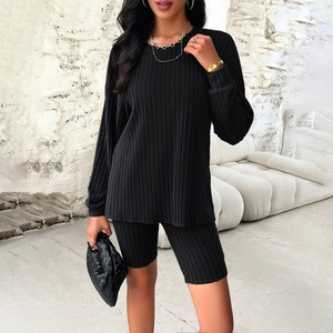 Women's black ribbed knit two-piece set featuring a long sleeve top and cycling shorts