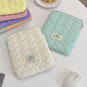 Detailed heart quilted laptop sleeve close-up in pastel colors with metal zipper